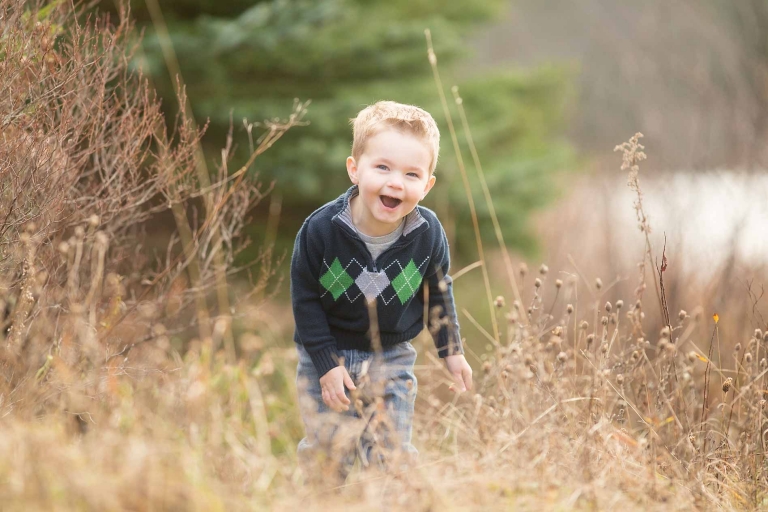 boy laughing in field