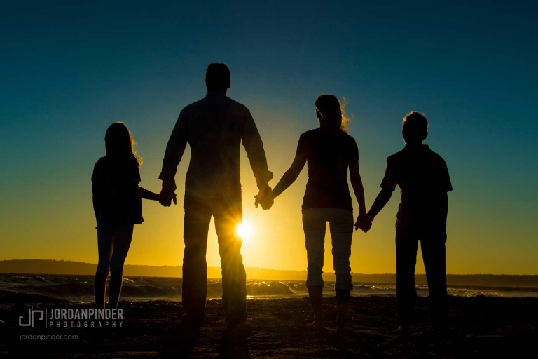 family of four standing together during a Crescent Beach sunset