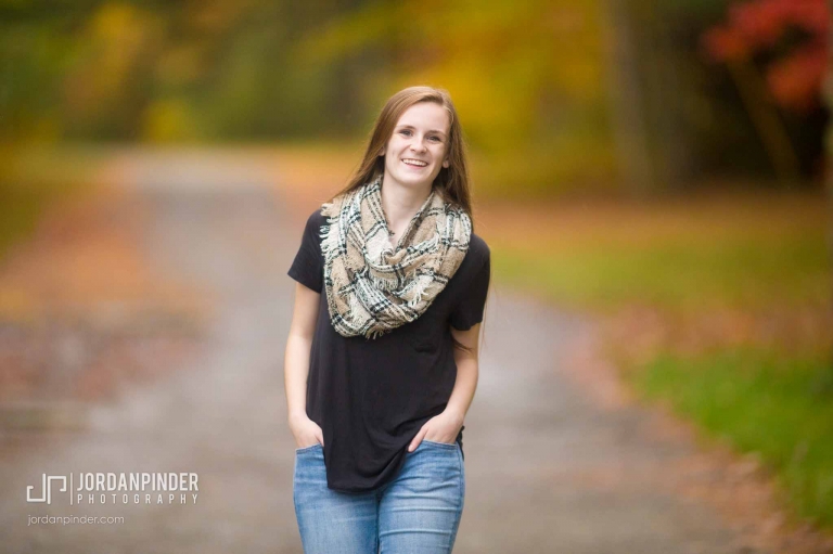 girl walking at Enclosure park in Miramichi, NB during graduation session