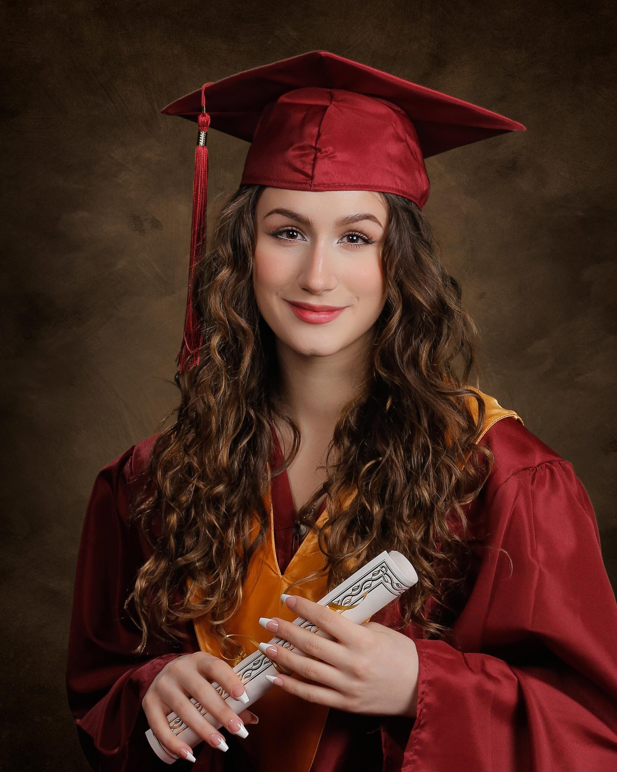cap and gown formal graduation portrait of high school girl holding a diploma