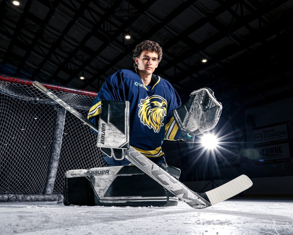 goalie in butterfly position in front of net